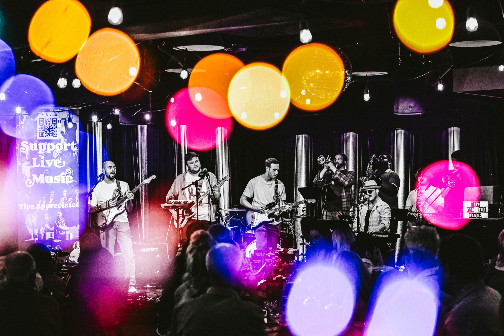 Bad Karl performing live under colorful stage lights